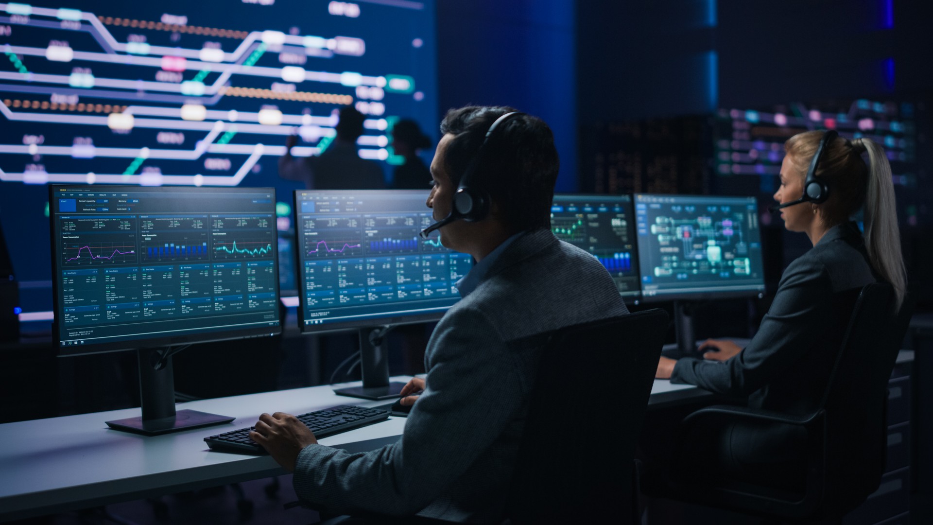 Team of Professional Traders Talking into Headsets Work on Computers with Screen Showing Finance Statistics, Charts Strategy, Stock, Telemarketing. Stock Firm Monitoring Room Stock Market Specialists